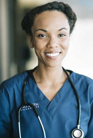 Herzing LPN student smiling in blue scrubs and wearing stethoscope